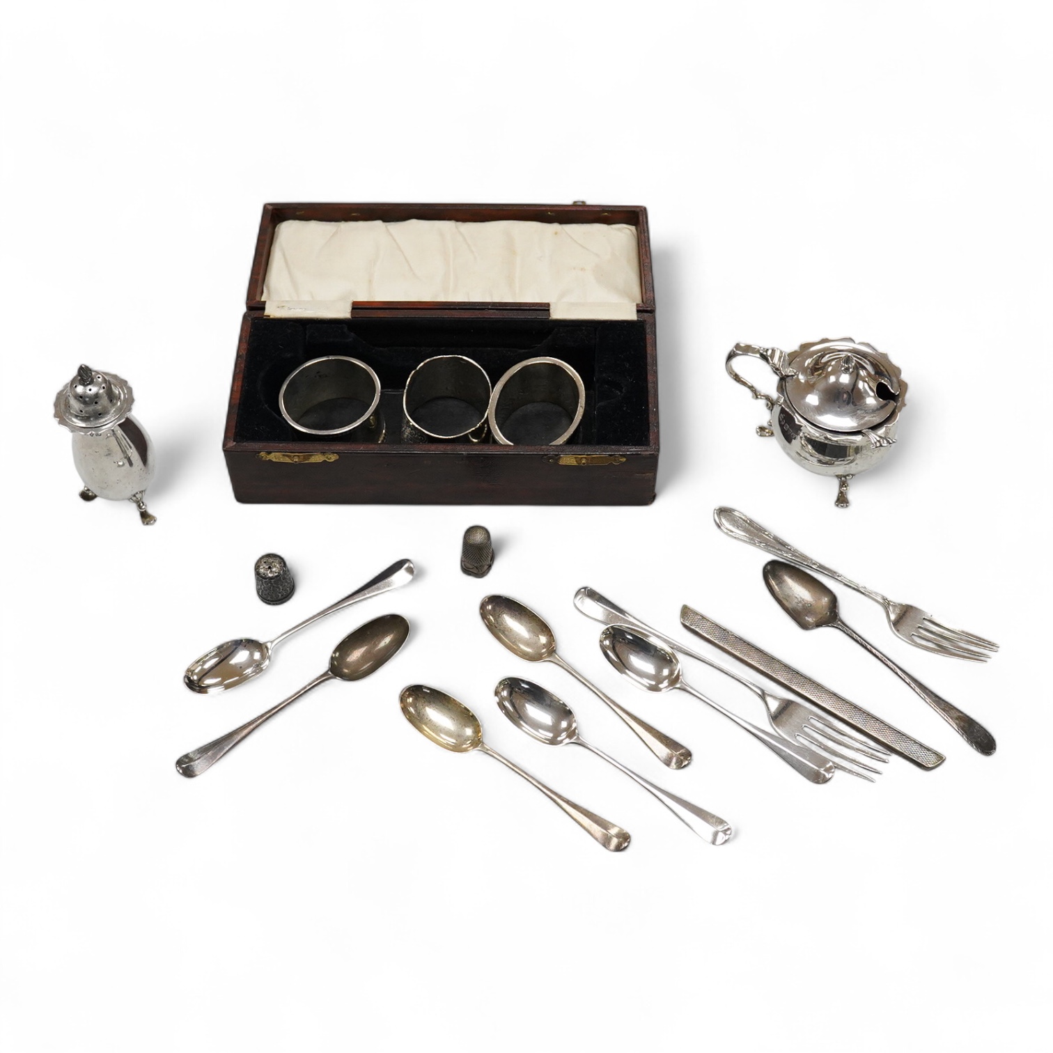 Three assorted 20th century silver napkin rings, a George V silver mustard pot and pepperette, a set of six late Victorian silver coffee spoons, London, 1883, and six other silver items.